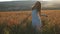 Young woman enjoying nature .Young beautiful woman walking among blooming poppy flowers