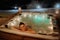 Young woman enjoying outdoor bathtub in her terrace during cold winter evening.