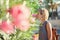 Young woman enjoying smelling aroma flowers outdoors