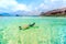 Young woman enjoying snorkeling on tropical island. Portrait of woman in clear water doing snorkeling