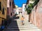 Young woman enjoying the sun in an alley of a small rural medieval village