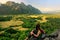 Young woman enjoying the view of farm fields in Vang Vieng, Laos