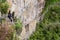 Young woman enjoying the view of Inca Bridge and cliff path near