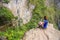 Young woman enjoying the view of Inca Bridge and cliff path near