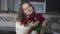 Young woman enjoys bouquet of rose flowers