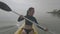 Young woman enjoys kayaking in the sea having fun paddleboarding at summer.