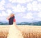 Young Woman Enjoys the Wheat Field Scenery