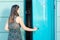 Young woman entering public toilet outside in park