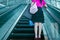 Young woman on escalator