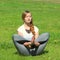 Young woman of European appearance does yoga in summer nature