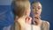 Young woman examining face skin mirror, unhappy with reflection, insecurities