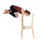 Young woman exercising with chair on white background