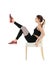 Young woman exercising with chair on white background