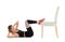 Young woman exercising with chair on white background