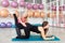 Young woman exercising with her fitness instructor