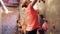 Young woman exercising at indoor climbing gym wall