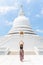 Young woman exploring the Japanese Peace Pagoda in Sri Lanka