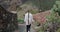 Young woman exploring spanish village Masca Gorge, Tenerife. Following tourist girl in white shirt walking on street