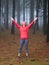 Young woman exploring stunning autumn foggy forest