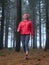 Young woman exploring stunning autumn foggy forest