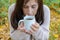 Young woman eyes closed with pleasure holding mug of hot tea in a hand. Red-haired girl holding her nose, holding a mug of hot tea