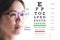 Young woman on eyesight test chart background. Eyesight and eye