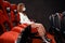 Young woman in a face mask sits in an empty cinema hall. Problems with visitors to theaters and concerts during the coronavirus