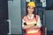 Young woman factory worker close up portrait in manufacturing job factory