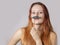 Young woman with fake moustache