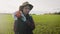 Young woman farmer in hat holding orange pumpkin in her hands the at field at sunset time . Pumpkin harvest. Agriculture