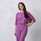 Young woman in fashionable purple jumpsuit