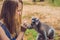 Young woman is fed Ring-tailed lemur - Lemur catta. Beauty in nature. Petting zoo concept