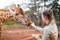 Young woman feeding giraffe in Africa