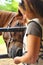 Young woman feeding horse