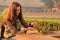 Young woman feeding Indian palm squirrels at Agra Fort, Uttar Pr