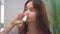 Young woman feeling blocked nose while allergy and spraying nasal spray