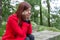 Young woman feeling depressed sitting on a forest