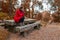 Young woman feeling depressed sitting on a stone table