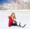 Young woman fell down on outdoor skating rink