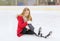 Young woman fell down on skating rink