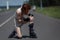 Young woman fell on the road and bruised her knee during skating.