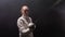 A young woman fencer in the dark smoky studio