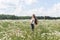 Young woman with a field with daisies