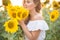 Young woman in a field of sunflowers. sunset light in the field of sunflowers