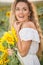 Young woman in a field of sunflowers. sunset light in the field of sunflowers