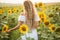 Young woman in a field of sunflowers. sunset light in the field of sunflowers
