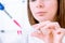 Young woman fill PCR microtubes with dispenser