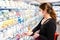 Young woman with filtering facepiece in a supermarket