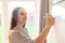 Young woman with flipchart board, she makes notes