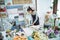 young woman florist working in flower shop make order flannel flower